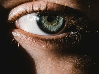 Close-up of a person's calm face with eyes closed, suggesting deep breathing.